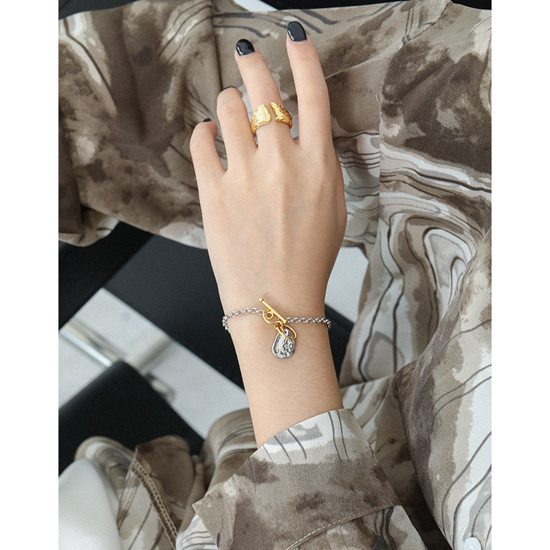 Double color bracelet with irregular charm